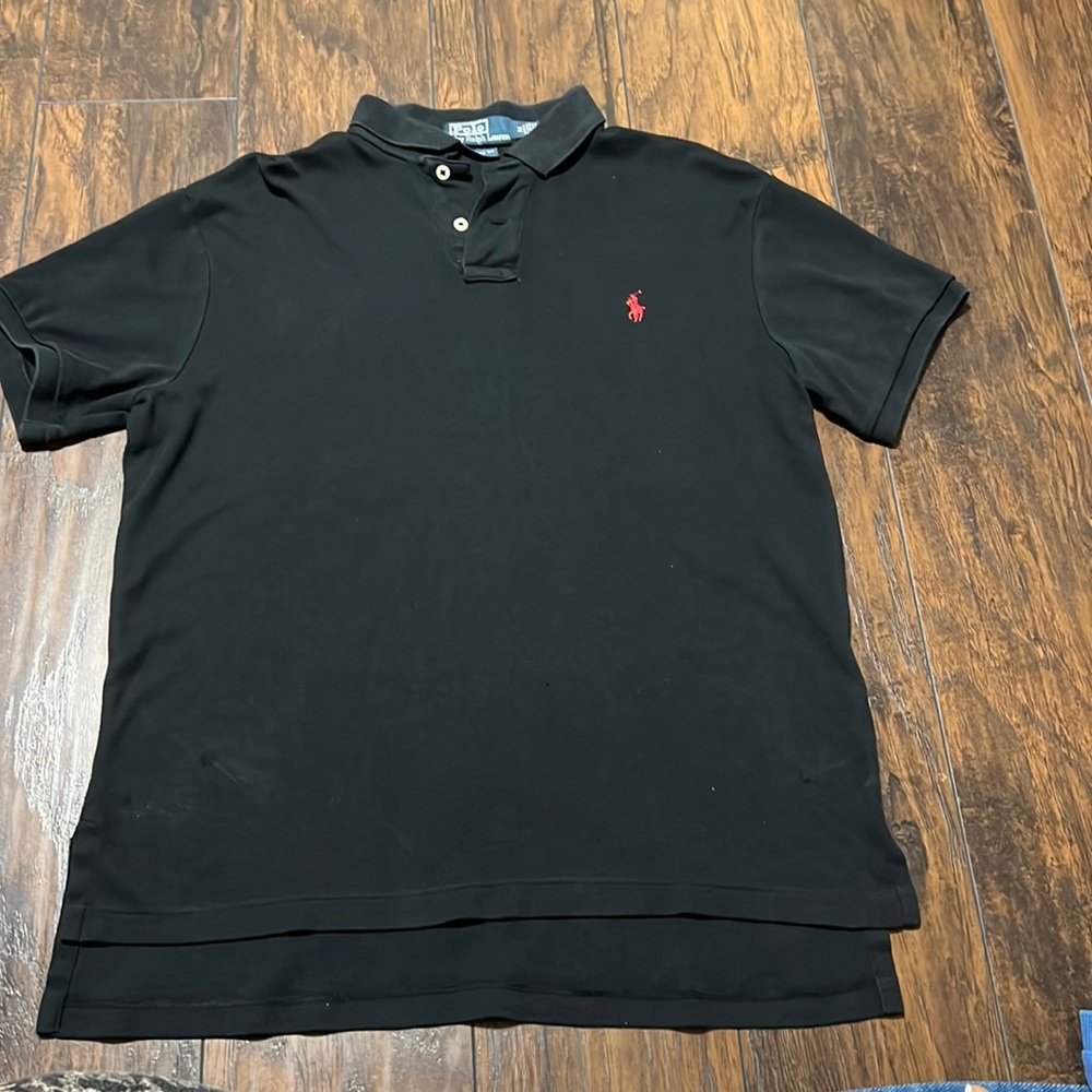 Black polo shirt by Ralph Lauren in medium size.